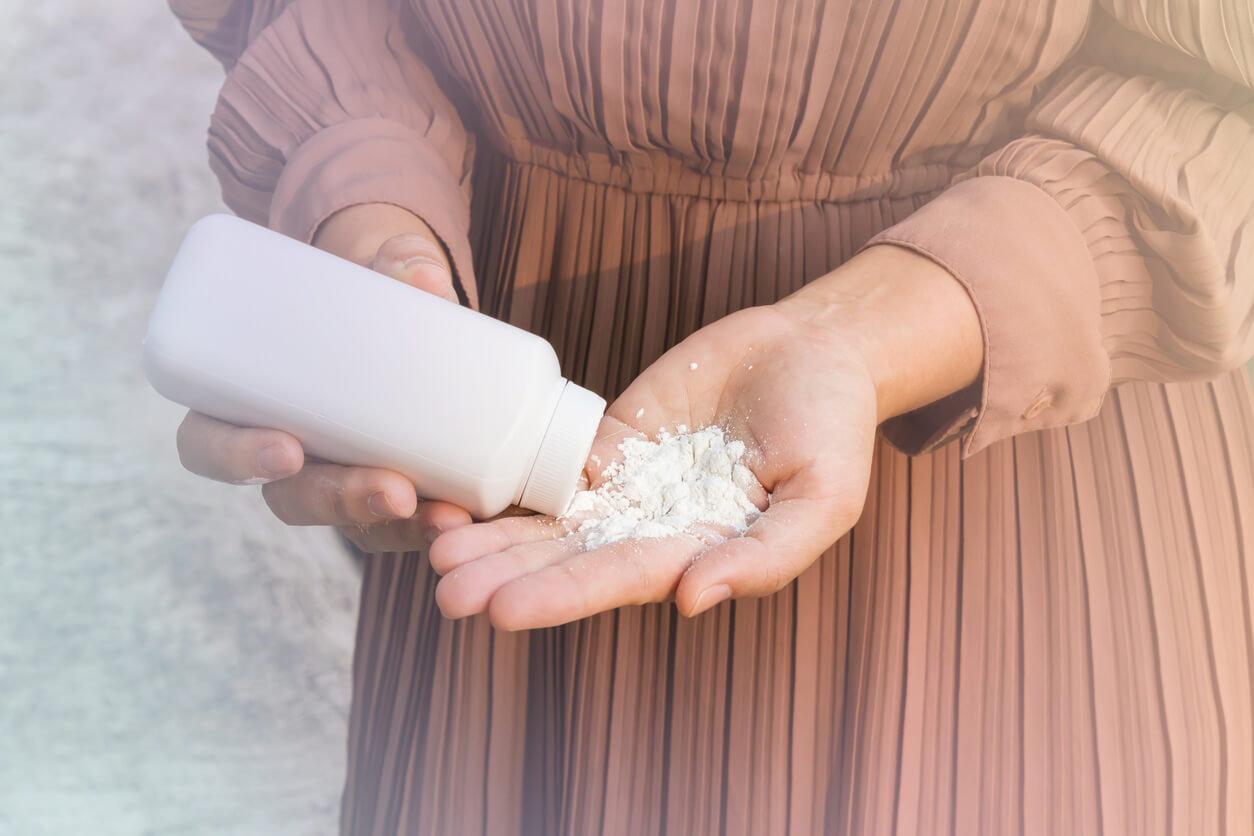 Woman pouring talcum powder