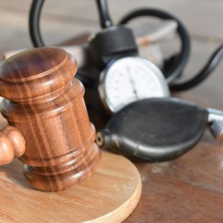 gavel and blood pressure monitor