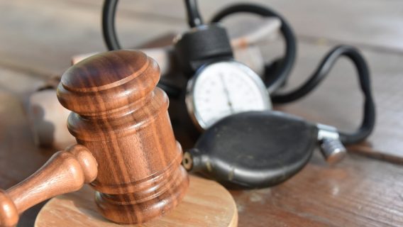 gavel and blood pressure monitor