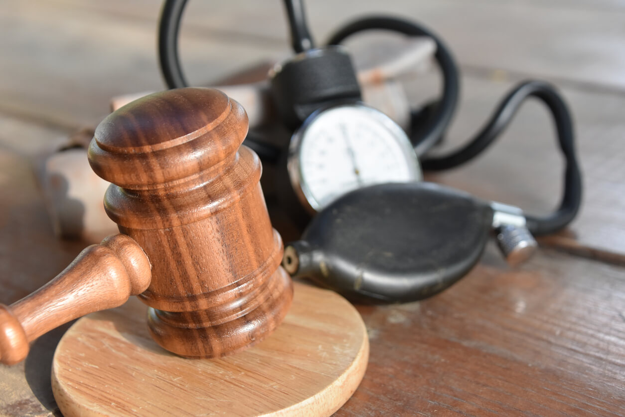 gavel and blood pressure monitor