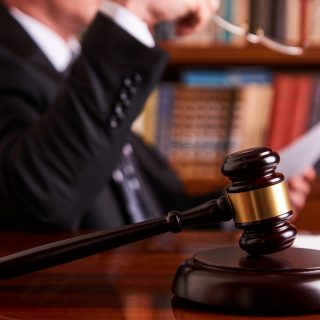 judge reviewing document and gavel