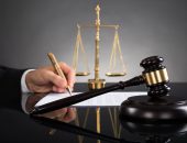 businessman signing settlement document