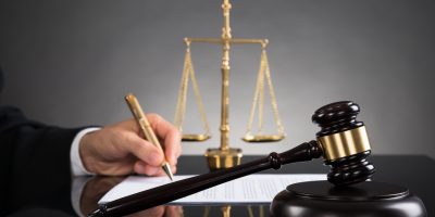 businessman signing settlement document