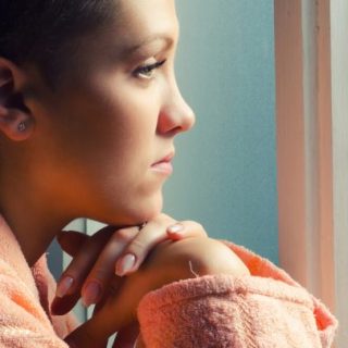 Young female patient staring out of window