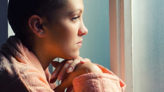 Young female patient staring out of window