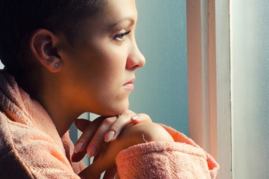 Young female patient staring out of window