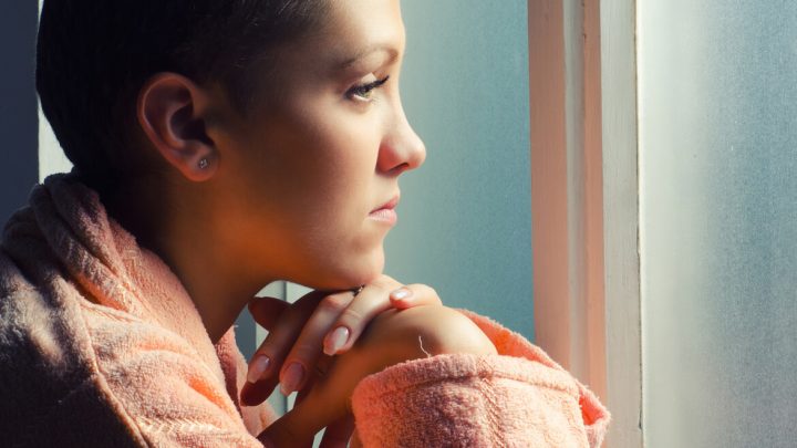 Young female patient staring out of window