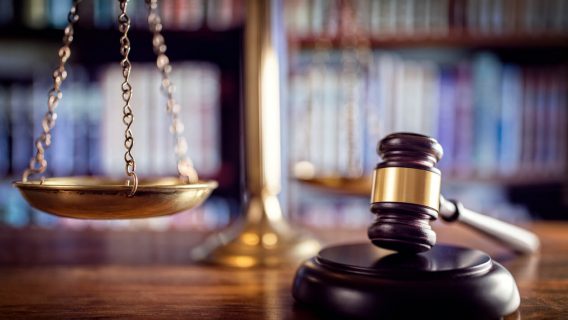 gavel and scale with books in background