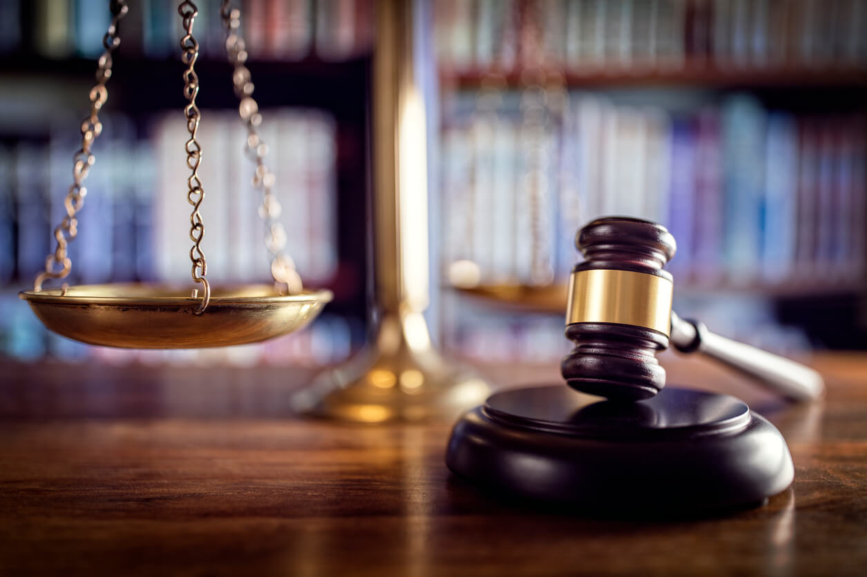 gavel and scale with books in background