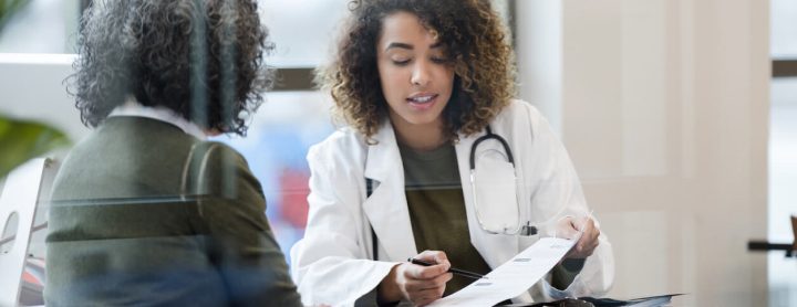 Woman consulting with doctor about medical results