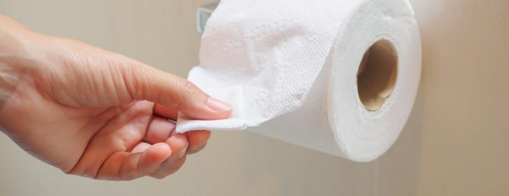 Hand grabbing toilet paper