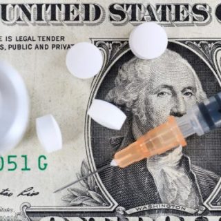 Syringe and pills on dollar bill