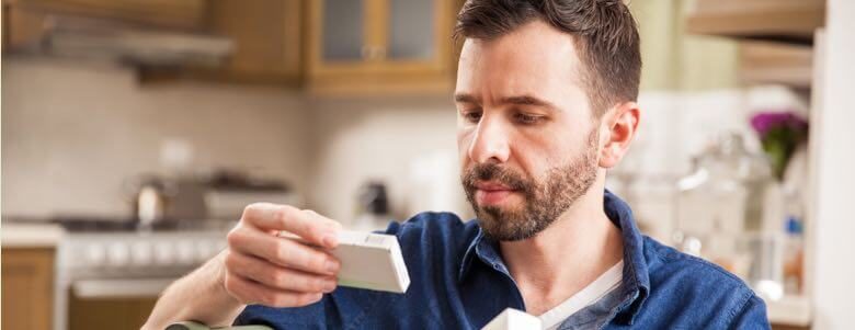 man reading drug labels