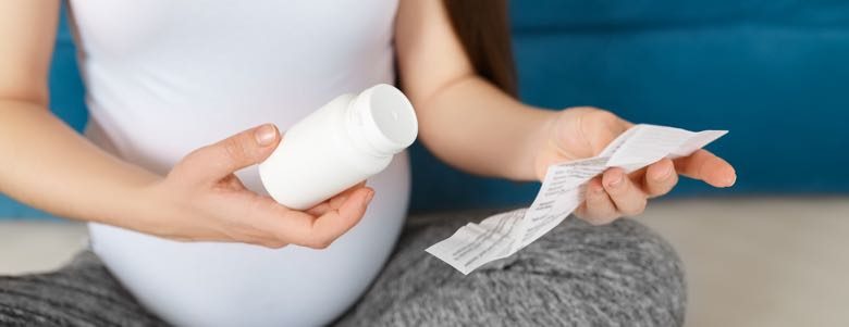 Pregnant woman going over prescription drug health risks