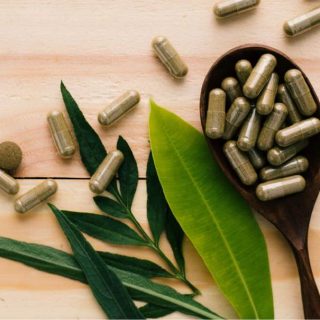 pills on top of a wooden spoon