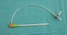 Introducer sheath kit with side-arm tubing, dilator, and puncture needle on a surgical drape