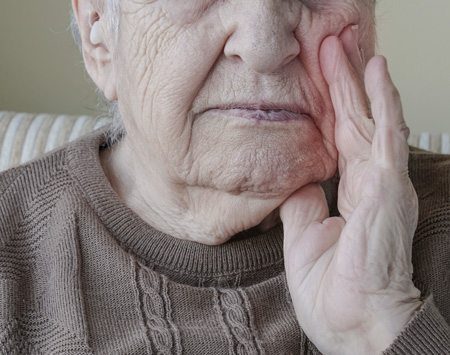 Elderly Man Clenching Jaw in Pain