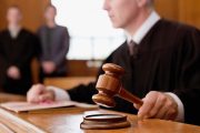 Judge holding gavel in courtroom