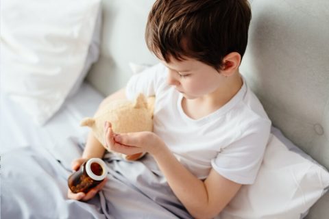 boy holding pills