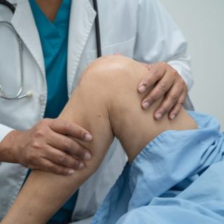 Doctor examining knee