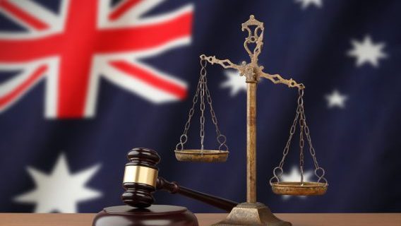 Gavel and scales with Australia flag background