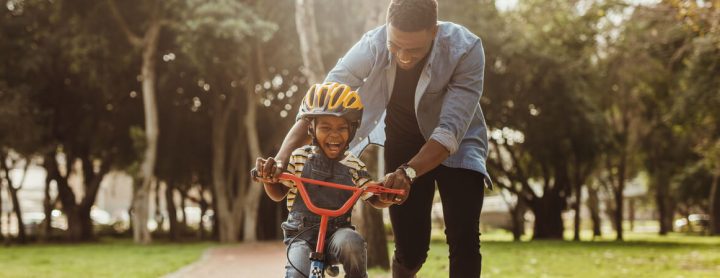 Man teaching his son how to ride a bike