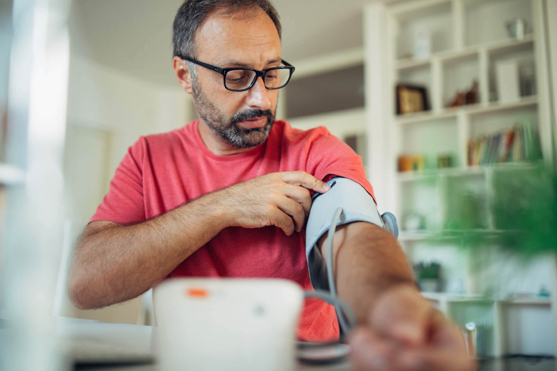 Older man checking blood pressure