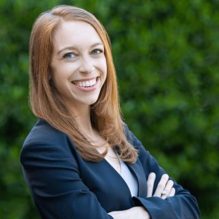 Professional headshot of attorney Marlene Goldenberg, smiling with arms crossed.