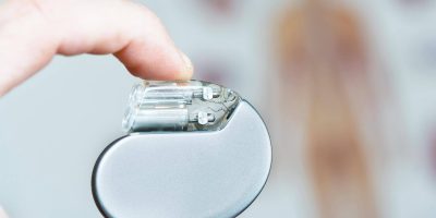 Person holding a heart pacemaker