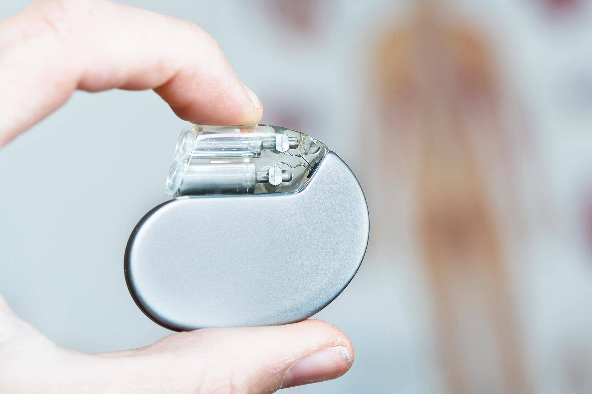 Person holding a heart pacemaker