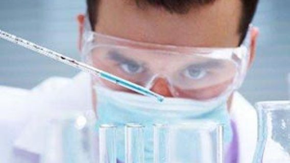 man working in lab with test tubes