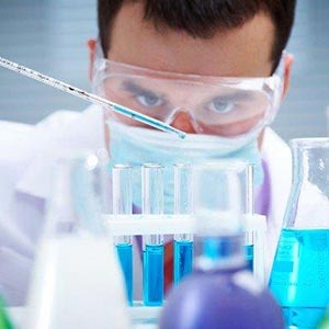 man working in lab with test tubes