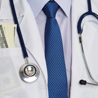 doctor's chest with a bunch of hundred dollar bills in coat pocket
