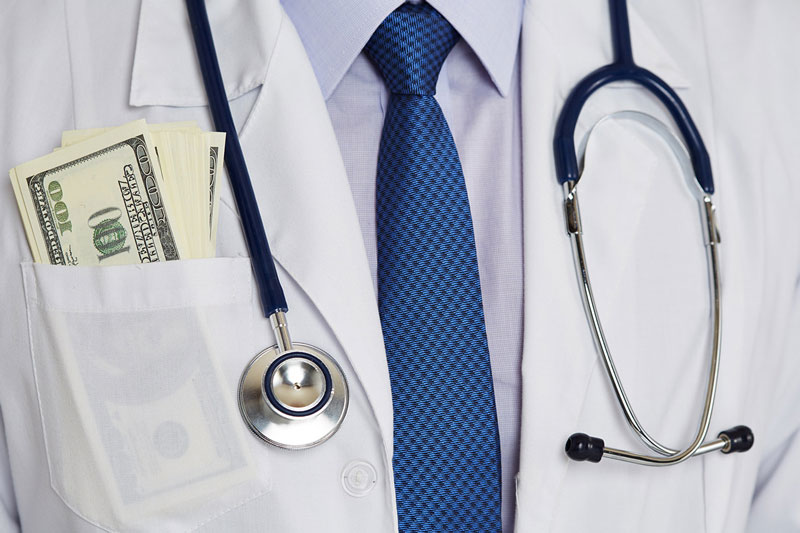 doctor's chest with a bunch of hundred dollar bills in coat pocket