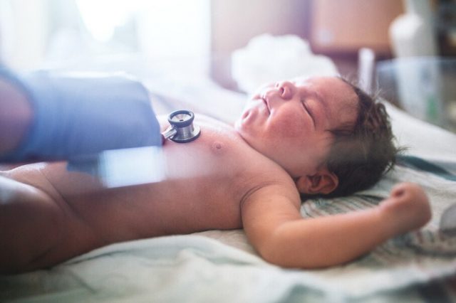 Doctor checking a newborn baby