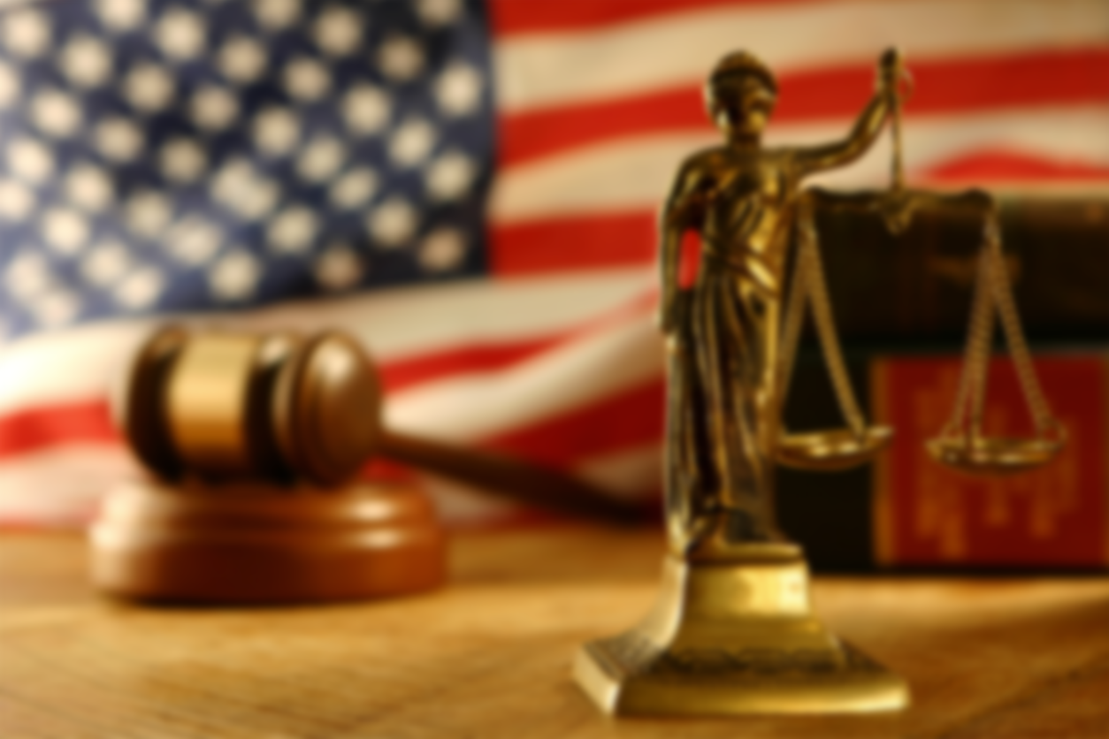 justice scales, gavel, and U.S. flag