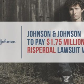 Sad young man sitting against fence