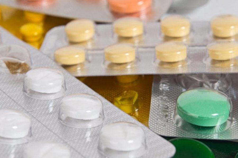 assortment of different colored pills in popcorn packaging