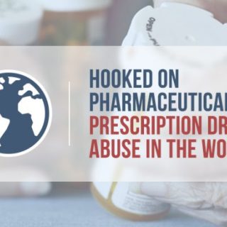 elderly hands holding prescription pill bottles