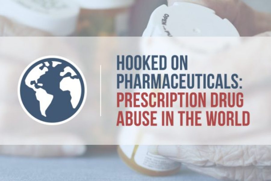 elderly hands holding prescription pill bottles