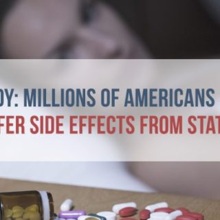 woman in bed looking at pills on nightstand