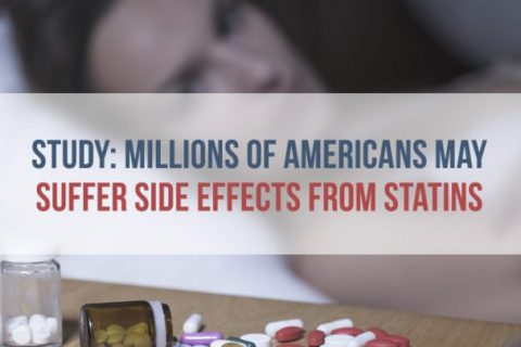 woman in bed looking at pills on nightstand