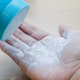 Pouring talcum powder onto open palm