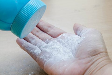 Pouring talcum powder onto open palm