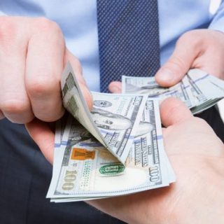 businessmen exchanging money