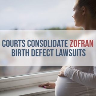 Pregnant woman looks out the window