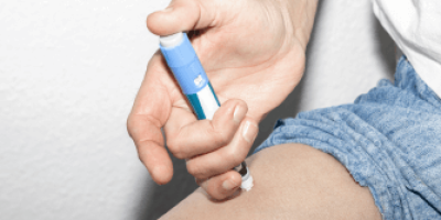 Person injecting themselves with injection pen