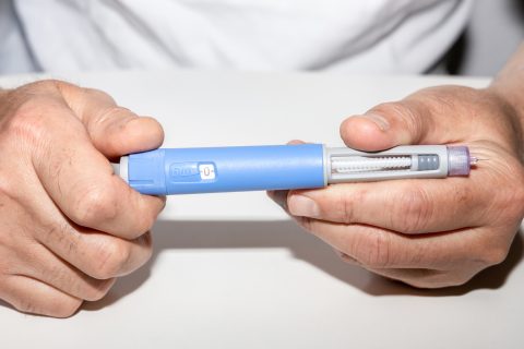 Person holding Ozempic insulin injection pen