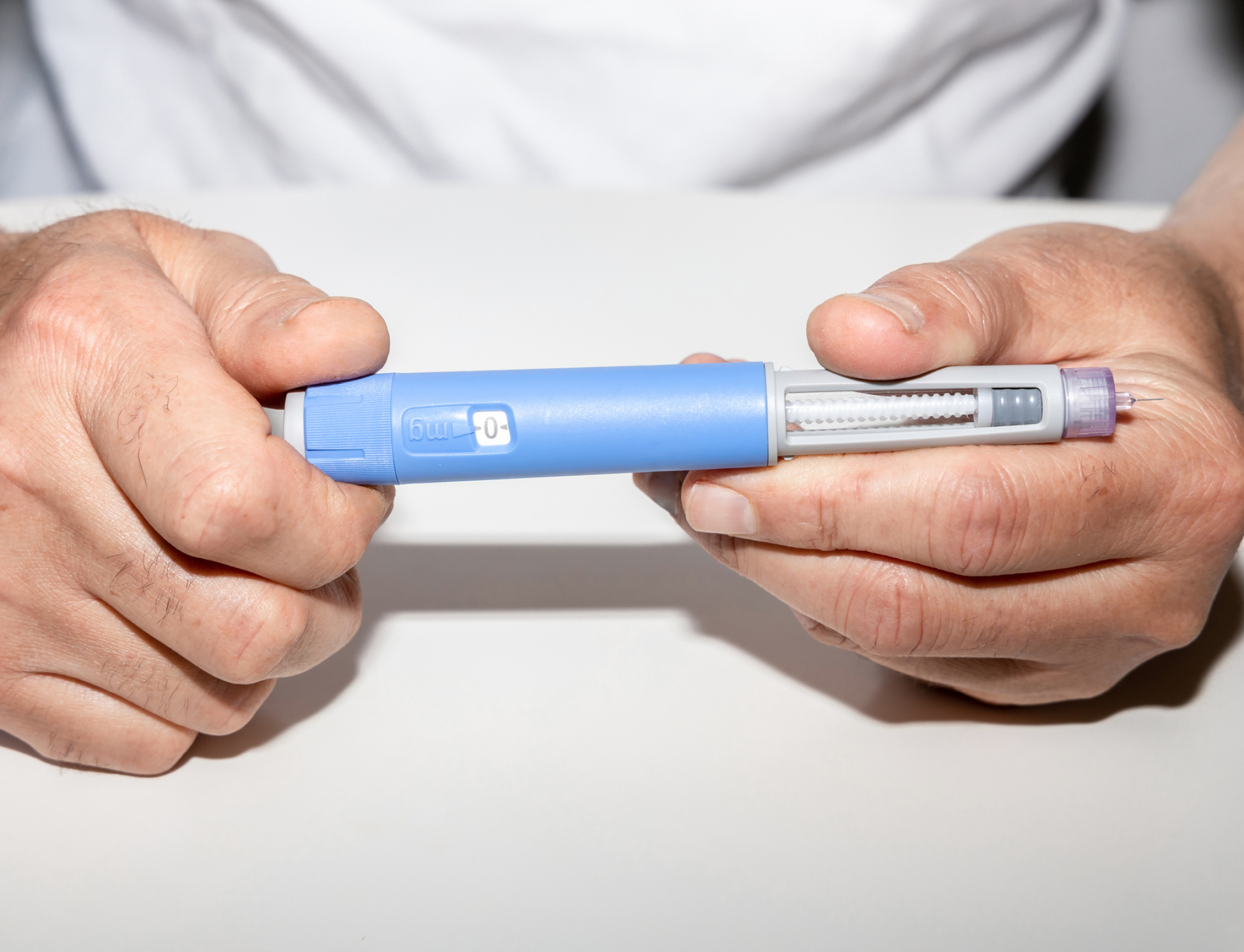 Person holding Ozempic insulin injection pen