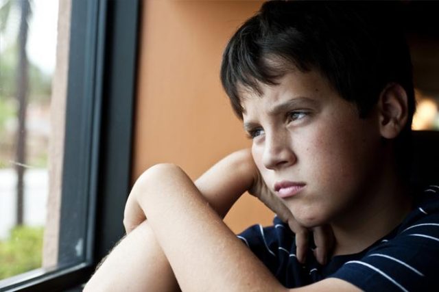 young boy looking out a window